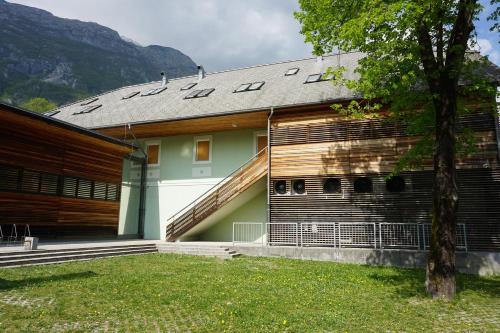 a house with a gambrel roof with a slope at Krona Apartments in Bovec