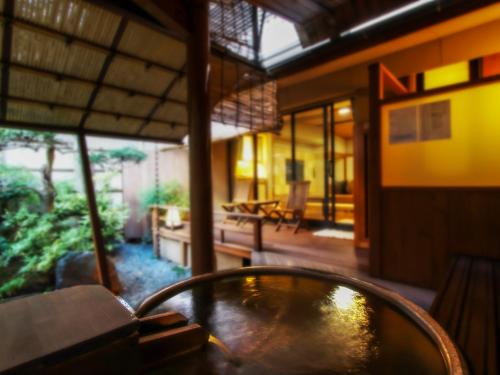 a room with a table and a room with a patio at Grandia Housen in Awara