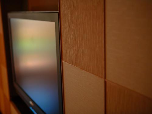 a glass door of a wooden cabinet with a wooden wall at Grandia Housen in Awara