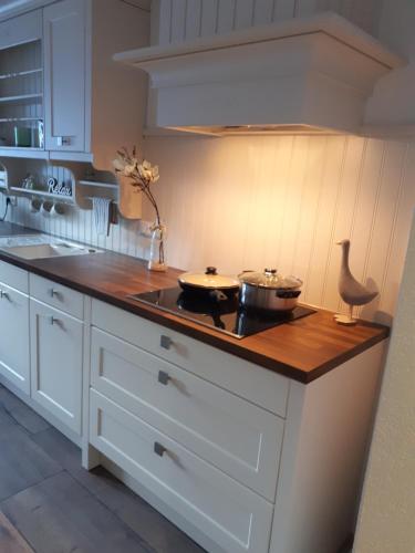 a kitchen counter with two pots and pans on it at Haus Resi in Berwang