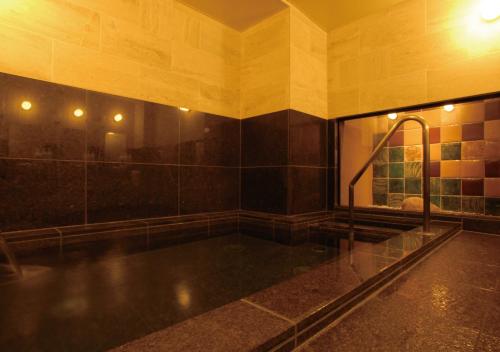 a large bathroom with a large tub with a shower at AB Hotel Nara in Nara