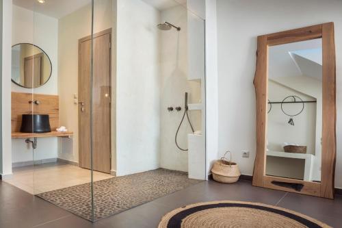 a bathroom with a shower and a glass door at Argostoli Marina Suites in Argostoli
