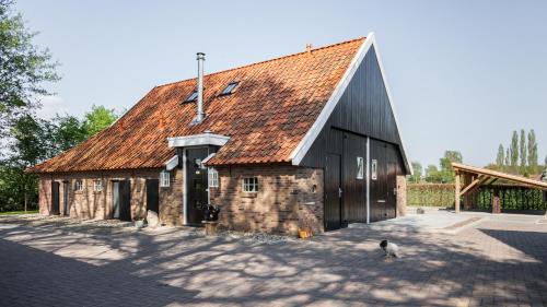 a barn with two cats standing in front of it at Bed & Breakfast De Schoppe in Winterswijk