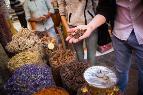 a group of people standing around a display of food at Novotel World Trade Centre Dubai in Dubai