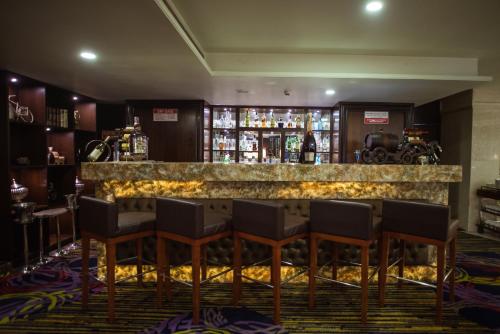 a bar in a hotel room with chairs and a counter at Shakun Hotels And Resorts in Jaipur