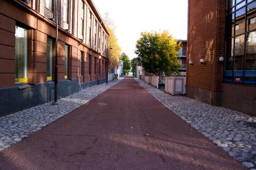an empty alley between two buildings in a city at Hotel Jahtihovi in Kuopio