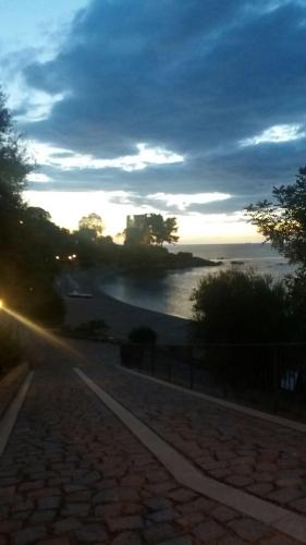 a view of the ocean at sunset with the sun setting at Appartamenti Quilici in Santa Maria Navarrese