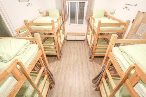 a dorm room with a bunch of bunk beds at T-Life Hostel in Longjing