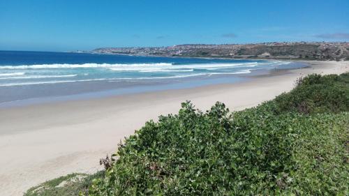 a view of a beach with the ocean at La Palma Villas in Mossel Bay