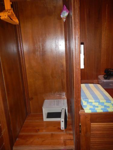 a small shower in a wooden room with a stove at Villa Campi Sorga in Senggigi 