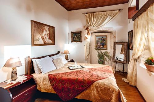 a bedroom with a large bed and a window at Hamam Suites Sifaka in Chania Town