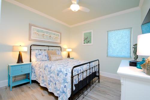 a bedroom with a bed with a blue nightstand and a bed sidx sidx sidx at Lighthouse 714 in Gulf Shores