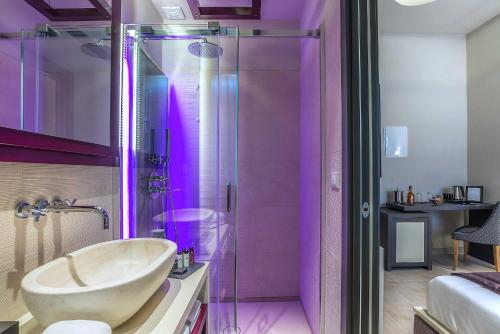 a bathroom with a sink and a shower at Via Veneto Prestige Rooms in Rome