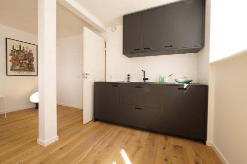 a kitchen with a sink and a tv on the wall at Rent A Place 1 - 4 in Copenhagen