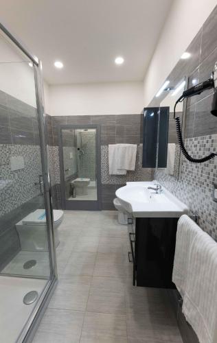 a bathroom with a sink and a toilet and a shower at Hotel Anfiteatro Flavio in Rome