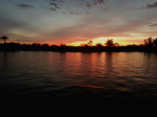 a sunset over a large body of water at Departamento En Tigre in Tigre