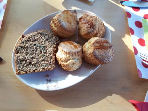 a plate of donuts and bread on a table at The Ring Farmhouse in Birr