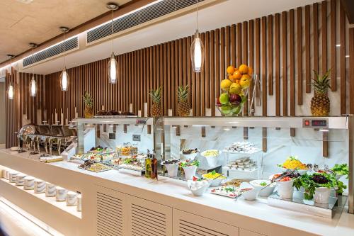 a buffet line with food on display in a restaurant at Mukarnas Taksim Hotel in Istanbul