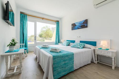 a bedroom with two beds and a window at Panorama in Port de Pollensa