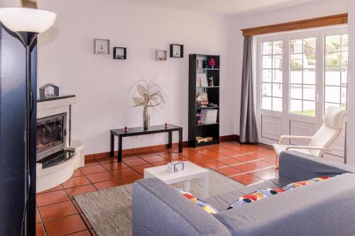 a living room with a couch and a fireplace at Casa do Norte (AL) in Biscoitos