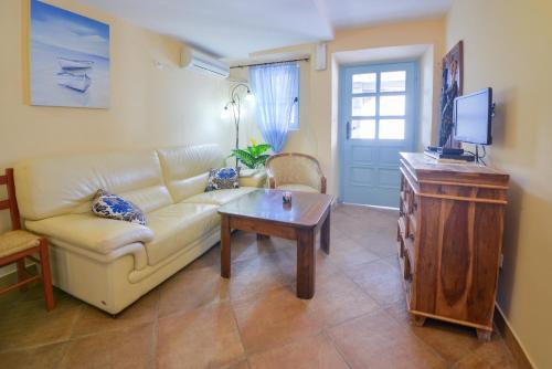 a living room with a couch and a table at Kazanegra Exclusive Apartments in Sveti Stefan