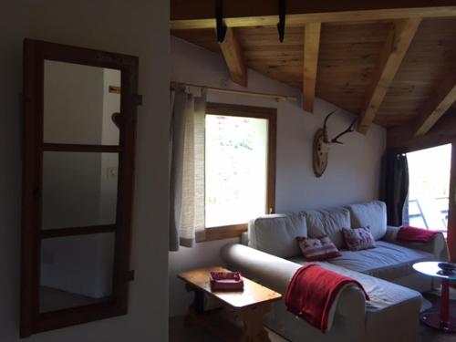 a living room with a couch and a window at Flims Chalet in Flims