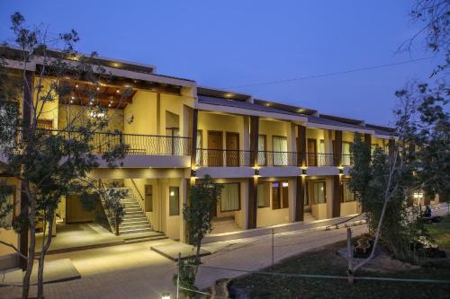 an exterior view of a building at night at Dreamworld Resort, Hotel & Golf Course in Karachi