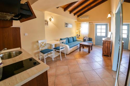 a kitchen and living room with a couch and a table at Kazanegra Exclusive Apartments in Sveti Stefan