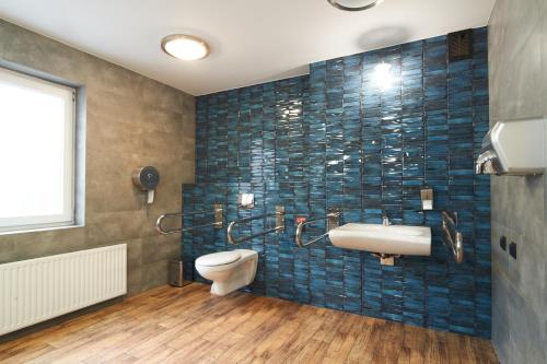 a bathroom with a sink and a toilet at Obiekt Hotelarski Patron in Warsaw