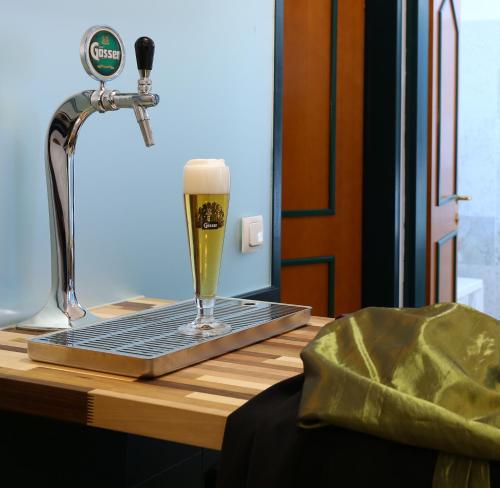 a glass of beer sitting on top of a table at Hotel Kongress in Leoben