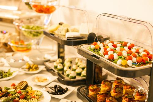 a buffet line with many different types of food at Victoria Bulevard Hotel in Braşov