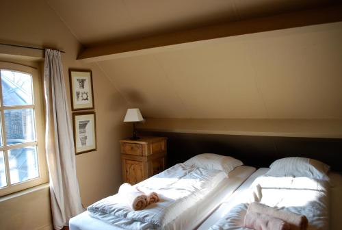 a bedroom with two beds and a window at Orshof in Oudsbergen 