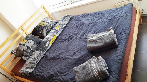 a bed with blue sheets and pillows on it at Walk distance to mokotow business park in Warsaw