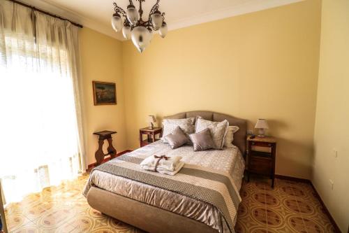 a bedroom with a bed with two towels on it at Scognamiglio Suites in Ercolano