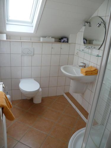 a bathroom with a sink and a toilet at Landgasthof Zur scharfen Ecke in Hildesheim