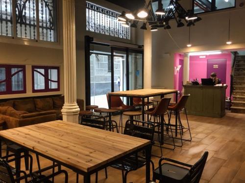 a restaurant with tables and chairs and a person in the background at Safestay Barcelona Gothic in Barcelona