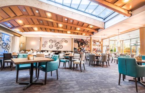 a restaurant with wooden ceilings and tables and chairs at The Jubilee Hotel in Nottingham