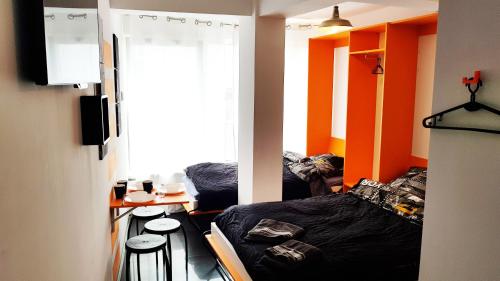 a room with two beds and a table in it at Walk distance to mokotow business park in Warsaw