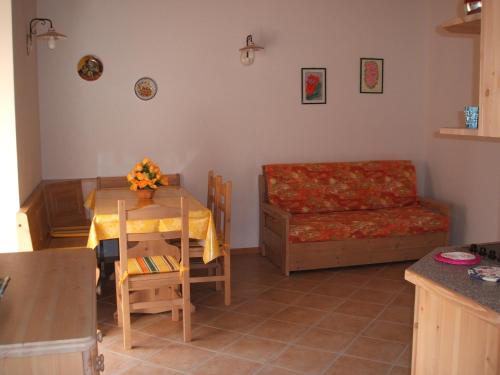 a living room with a table and a couch at Agritur Maso Talpina in Mori