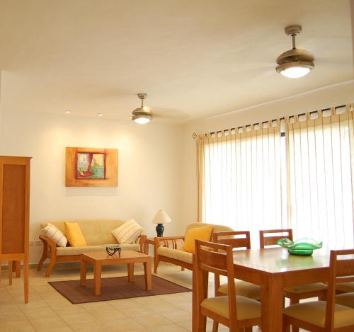 a living room with a couch and a table at Villas Mayaluum Cozumel in Cozumel