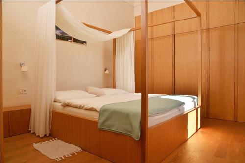 um pequeno quarto com uma cama e uma janela em Grad Goričko em Grad