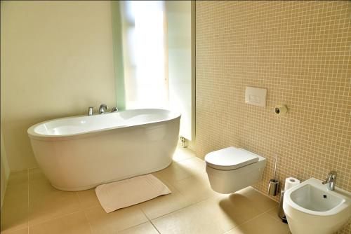 a bathroom with a white tub and a toilet at Grad Goričko in Grad