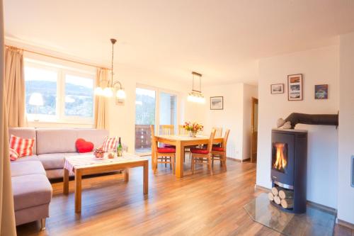 a living room with a couch and a fireplace at Ferienwohnungen Karwendelbahn in Mittenwald