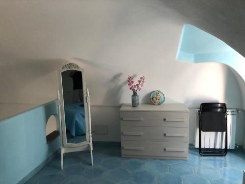 a bedroom with a bed and a dresser and a mirror at Casa Cucurullo in Procida
