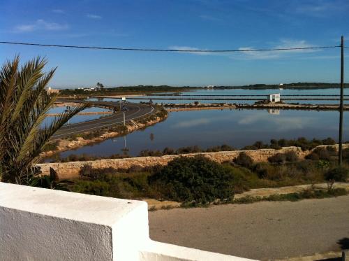 a view of a river with a road and a bridge at Apartamentos Eugenio la Sabina in La Savina