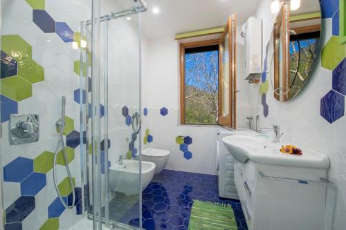 a bathroom with a toilet and a sink and a shower at Casa Loreto, Agerola in Agerola
