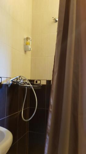 a shower head in a bathroom with a sink at Lara in Solochin