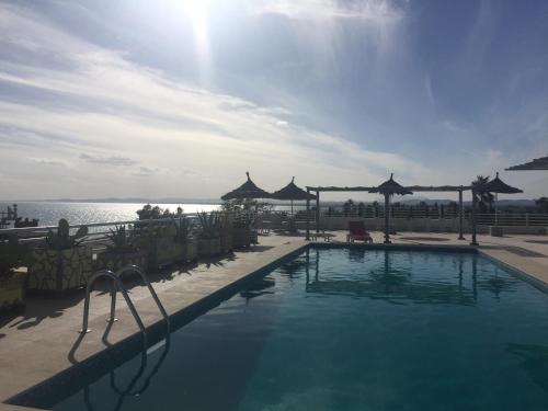 a swimming pool with a view of the ocean at Hotel La Residence Hammamet in Hammamet