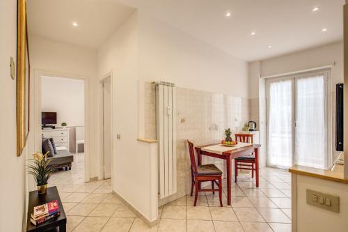 a kitchen and dining room with a table and chairs at Rome4Guest Ostia in Lido di Ostia