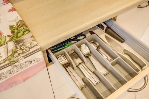 a drawer with scissors and other kitchen utensils at Rome4Guest Ostia in Lido di Ostia